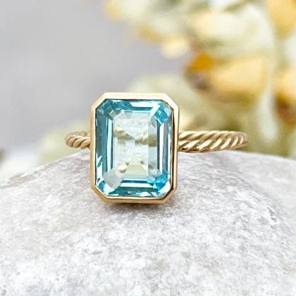 Blue topaz solid gold solitaire eng..
